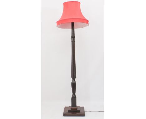 A mahogany standard lamp - 1930s, converted from a 19th century four-poster bed post, the reeded baluster column with stiff l