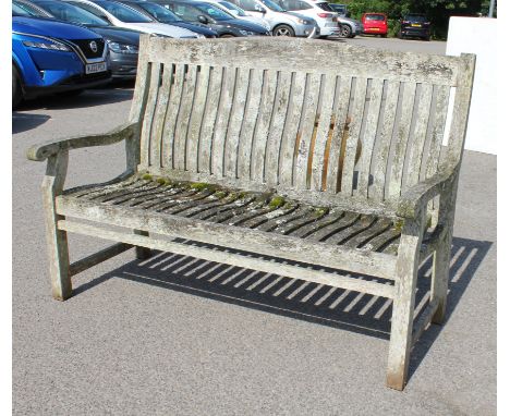 A weathered teak garden bench