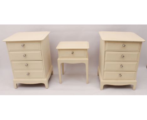 A pair of modern cream-painted bedside chests - 1970s, later painted and replaced handles, with four bevelled drawers, raised
