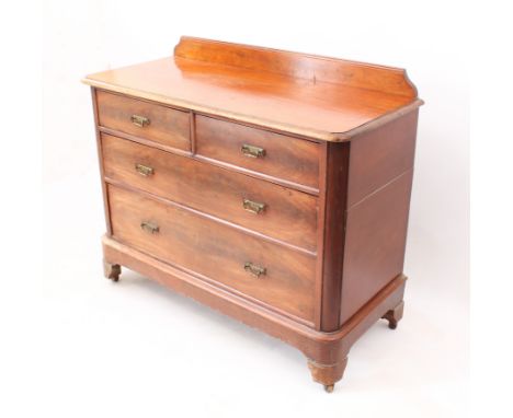 A late 19th century mahogany chest of drawers - the moulded top with short upstand over two short and two long graduated draw