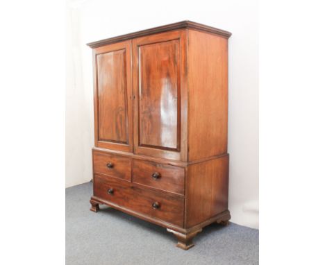 A George III mahogany linen press, of compact proportions - the dentil carved cornice over a pair of well-figured panelled do