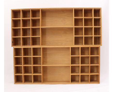 A graduated pair of light oak open book and display shelves - rectangular with closed backs, each with two large central shel