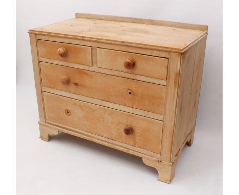 A waxed pine chest of drawers - early 20th century, the top with a short upstand, over two short and two long graduated drawe