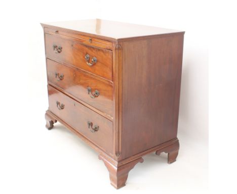 A George III mahogany straight-front chest of drawers - the moulded top with brushing slide, over three long graduated drawer