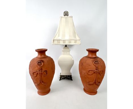 A pair of Oriental red earthenware vases - 20th century, ovoid form with moulded decoration of dragons amidst clouds and moul