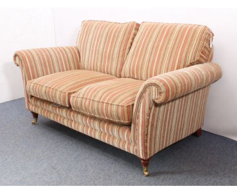 A modern Burghley two-seater sofa by Parker Knoll - upholstered in multi-coloured striped fabric in tones of buff, brick-red 
