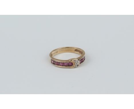 A 9ct yellow gold, ruby and diamond ring - Birmingham import hallmarks, the central diamond-set crescent flanked by rows of c
