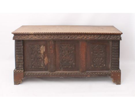 A Continental carved oak cassone - 19th century, the chip-carved, three plank top over a three panel front carved with stylis