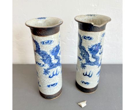 A pair of Chinese crackle glaze sleeve vases - first half 20th century, painted in blue and white with two dragons chasing a 