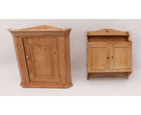 Two pieces: 1. A pine hanging cabinet - with a single shelf back over a pair of panelled doors enclosing five shelves, over a