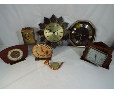 A lot to contain of five clocks to include Metamec wall clock, three mantle clocks, a barometer and similar. 