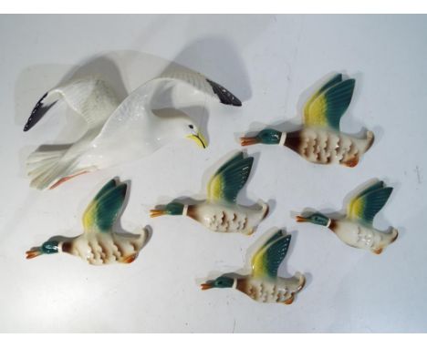 Six ceramic wall plaques in the form of flying ducks probably Keele Street Pottery and a Beswick wall plaque in the form of a
