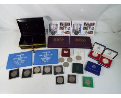 A vintage cash tin with key, four commemorative coin sets comprising the Coinage of Great Britain and Northern Ireland 1977 x