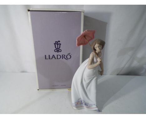 Lladro - A boxed Lladro figurine of a lady with a parasol, Afternoon Promenade # 6790, approximately 27 cm (h). Est £30 - £50