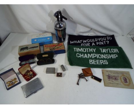 A mixed lot of vintage collectables to include a Sparklets soda syphon, Will's cigarette cards  album, a white metal cigarett
