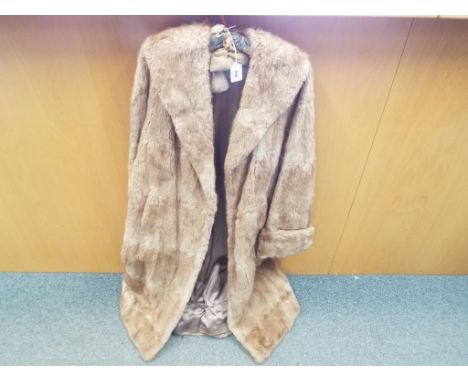 A lady's fur coat in light brown with slip pockets, retailed by Marshall and Snelgrove, Southport. 