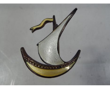 Ivar Holth - a 1960's Norwegian enamelled sterling silver Viking Ship by Ivar Holth with white enamelled sail and yellow flag