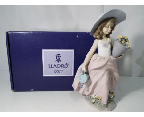 Lladro - A boxed Lladro Collector's Society figurine depicting a young girl with a watering can and a flower pot, A Wish Come