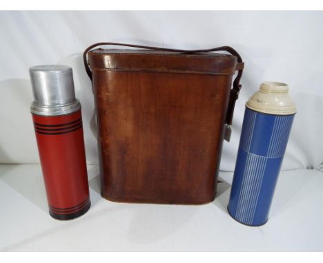 A large scale vintage leather flask holder with three internal flask compartments containing a vintage Icy Hot vacuum flask a