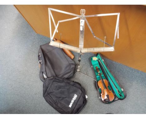 A beginner's violin and bow n protective case, three soft protective guitar cases and a white metal music stand (qty)