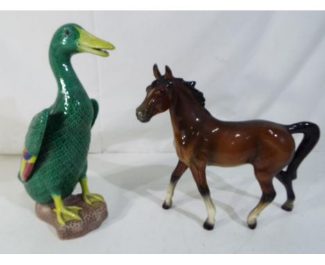 A ceramic model depicting a horse possibly Goebel marked 2176 and a Chinese ceramic model depicting a duck, approximately 20.