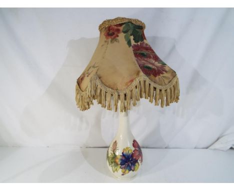 Moorcroft Pottery - a lamp base with shade, decorated with hibiscus on a cream ground, Royal Warrant paper label to the base,