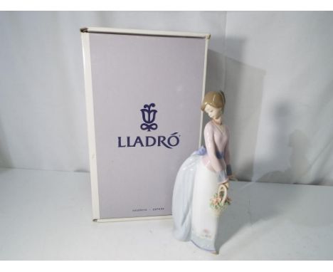 Lladro - A boxed Lladro Collector's Society figurine of a lady with a basket of flowers entitled Basket of Love # 7622, stamp