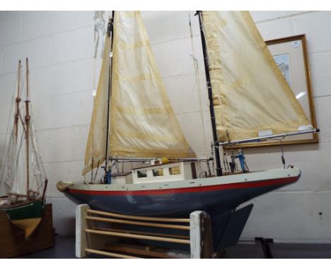 A very large twin masted pond yacht with plastic hull and wooden deck, approximately 165 cm [h] including masts, 130 cm bow t