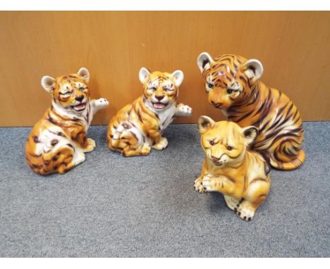 Four ceramic figurines depicting tiger cubs, largest approximately 33 cm (h) (4)