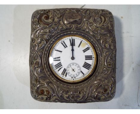 A Goliath size watch presented in a decorative folding case to use as a travelling clock. Argentan case, stem wind lever esca