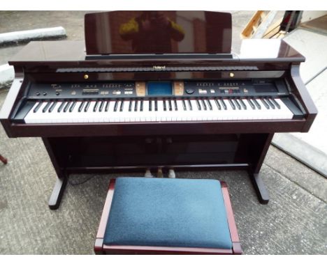 A Roland KR-7 digital intelligent piano with stool, light use. Est £80 - £120