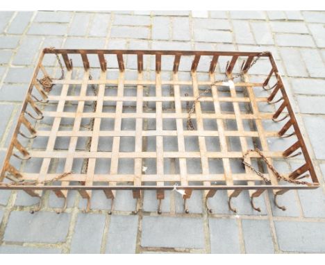 A cast iron blacksmith made kitchen hanging pot rack /shelf, the central lattice shelf section suspended from four chains and