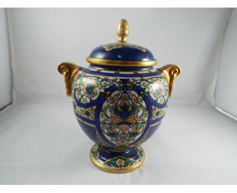 Royal Worcester - a Royal Worcester twin handled urn - covered vase with floral and gilt decoration on a mottle blue ground, 