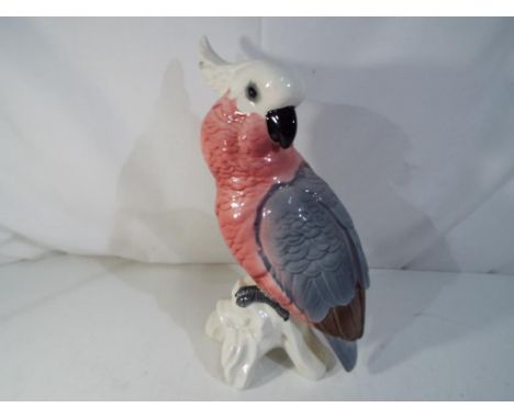 Beswick - a ceramic Beswick figurine depicting a cockatoo in the pink and grey colourway, approximately 29 cm (h). Estimate £