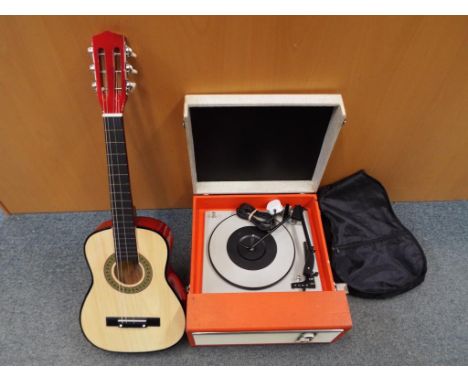 A retro record player model no. MP12, serial 017029 and a child's practice acoustic guitar with carry case (2)