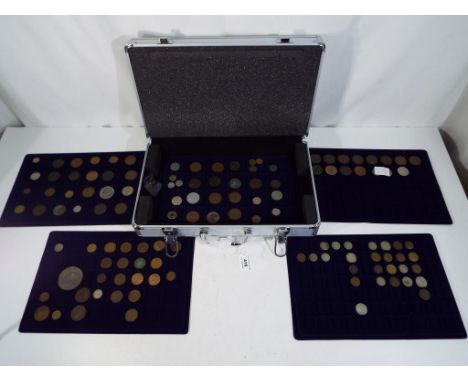 An aluminium case containing a quantity of UK and Foreign coins, pre and post decimalisation 