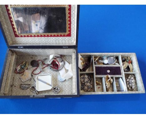 A jewellery box containing a quantity of vintage costume jewellery to include brooches, tie pin, paired earrings also include