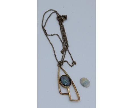 Boxed black opal triplet pendant on sterling silver mount and chain together with one loose opal in case. Loose opal shows fl