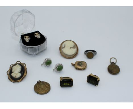 A collection of costume and mourning jewellery. Two mourning brooches with hair, one button converted into a brooch, two came