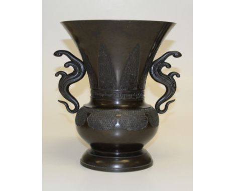 A large Chinese bronze Gu-shape vase, late 19th century. Flared baluster form with organic handles, incised stiff leaf and Gr