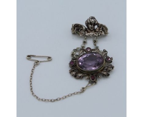 Continental Art Nouveau silver and amethyst brooch. The chain detailed with baroque seed pearls and the main setting surround