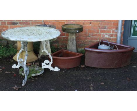 A white painted aluminium garden table, 88cm diameter, a reconstituted stone sundial, bird bath, two stoneware corner mangers