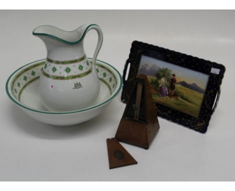 A Vienna porcelain tray painted with a courting couple in a landscape, 35cm, a metronome and a Hodgson wash jug and basin