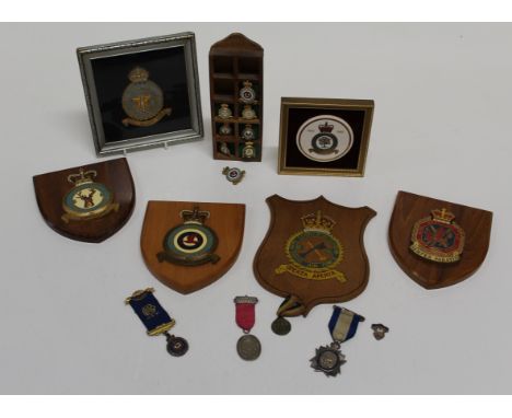 A gilt thread embroidered RAF 81 Squadron badge, framed 18 x 18cm, four wood shields and a small collection of enamel badges,