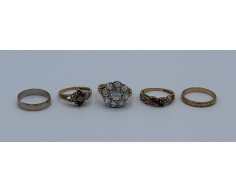 A collection of five gold rings, all 9ct. One missing stones, size N. One ruby and diamond, size N. One paste cluster ring, s