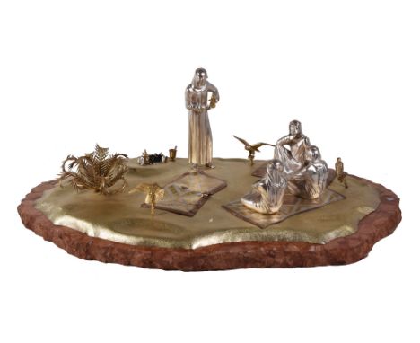  Asprey, a silver and parcel three colour gilt model of Arabs in the Desert,   partial marks, resting from hawking, on an irr