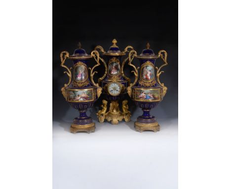 A French porcelain Sevres-style blue-ground gilt-metal mounted two-handled clock garniture, third quarter 19th century, paint