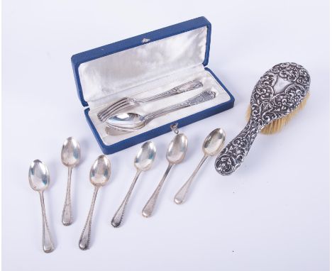 A collection of silver wares including spoons, hand mirror etc.