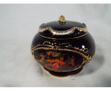 Ardleigh Elliott - a ceramic lidded bowl in the form of a musical box, issued in a limited edition of 'The Fire Bird', mechan