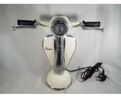 An unusual table lamp in the form of a Vespa scooter, approximate height 41 cm (h). Estimate £80 - £120